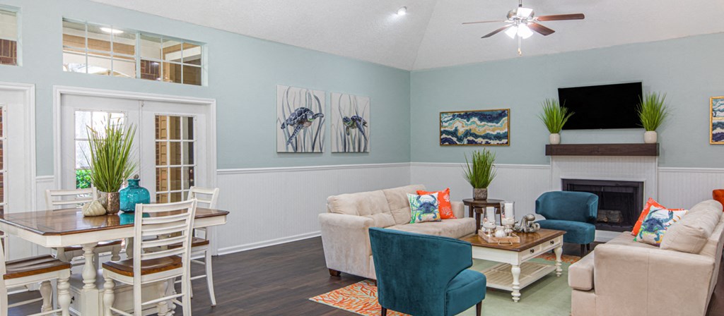 a living room with a fireplace and a table and chairs