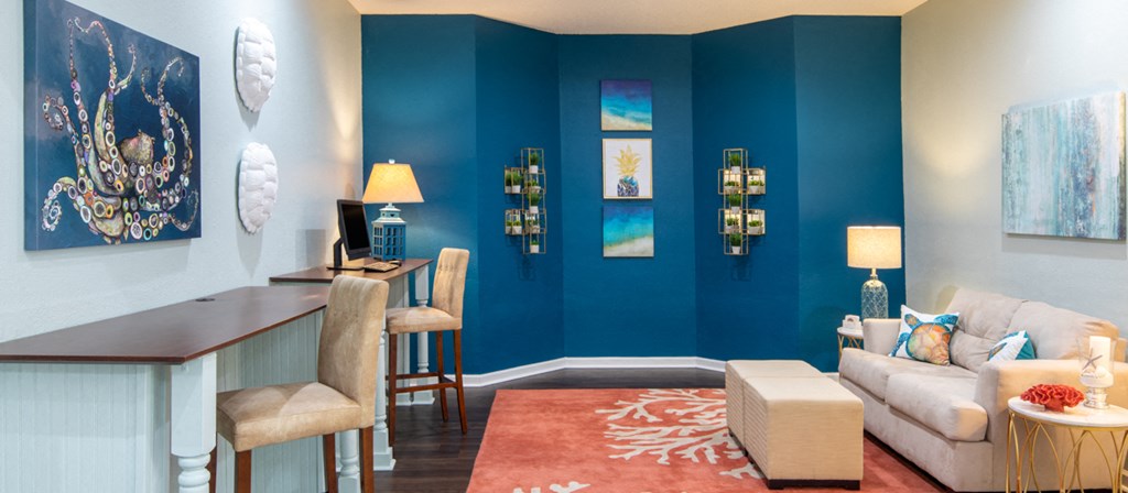 a living room with blue walls and a dining room table