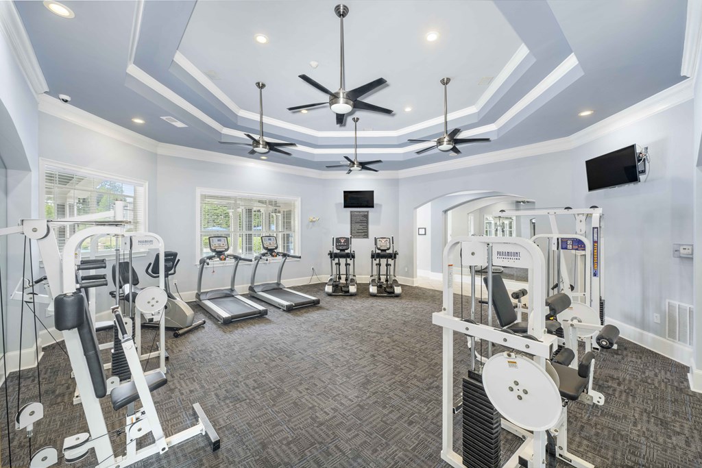 a gym with treadmills and other exercise equipment
