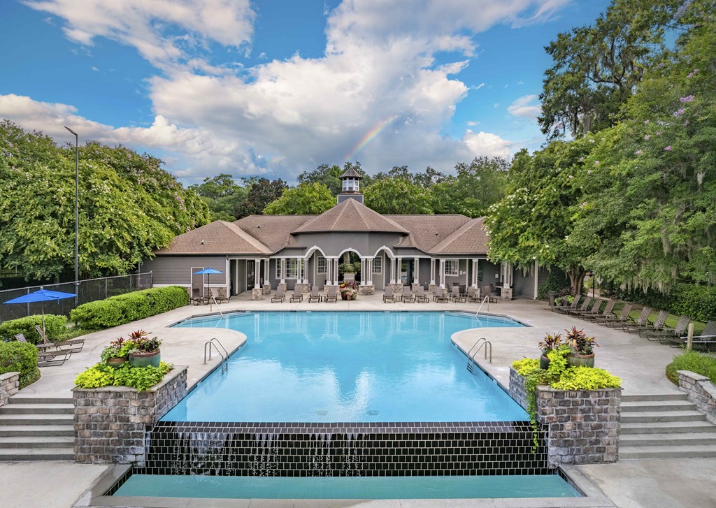 a swimming pool with a house in the background