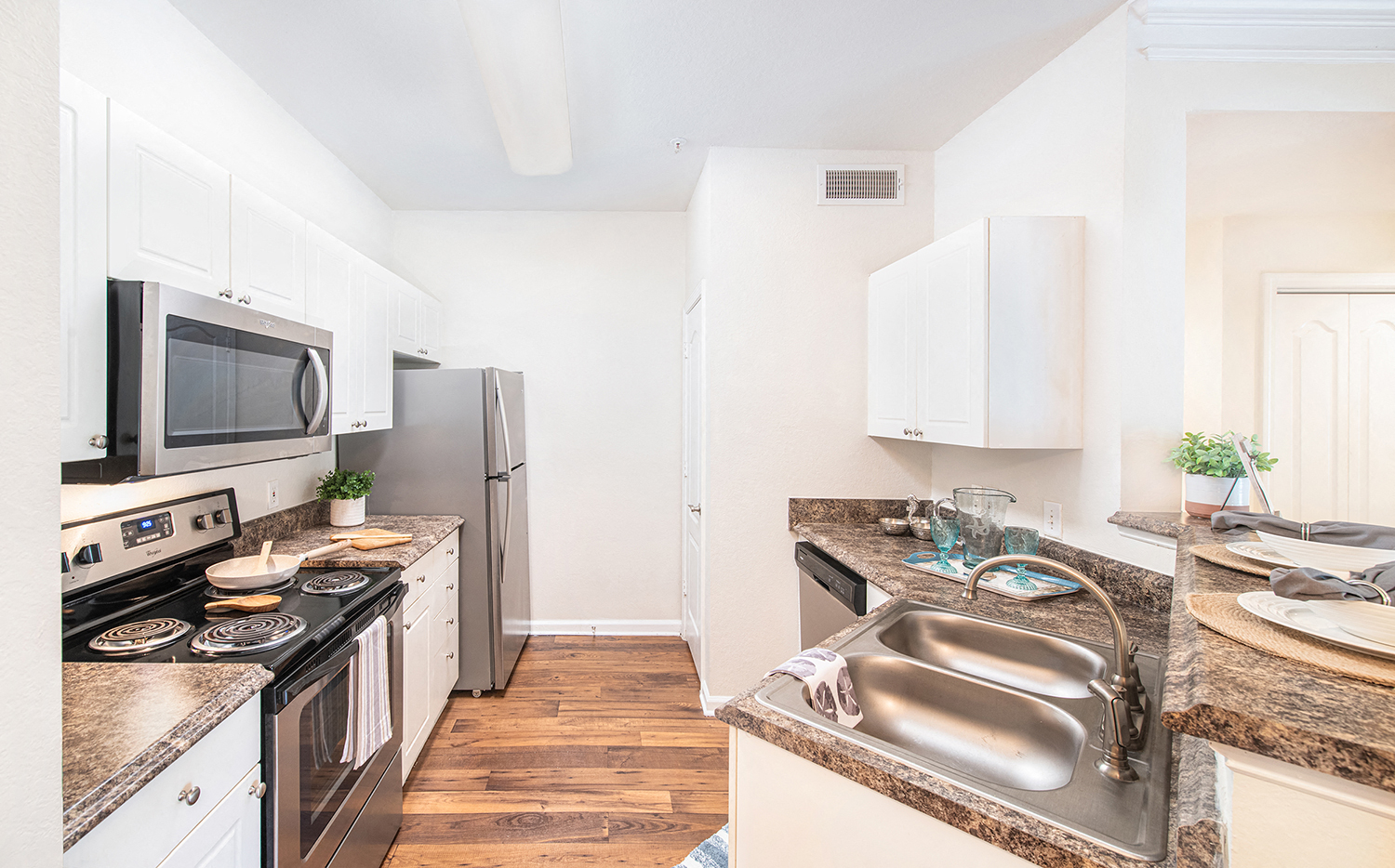 a renovated kitchen with stainless steel appliances and granite counter tops