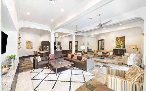 A living room with a variety of furniture including a sofa, armchairs, and a coffee table.