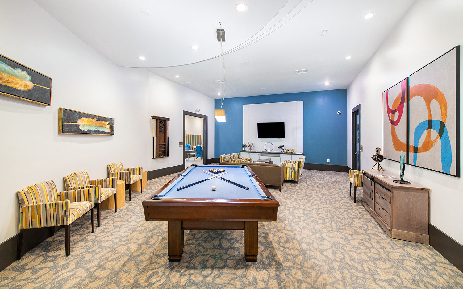 a game room with a pool table and a bar