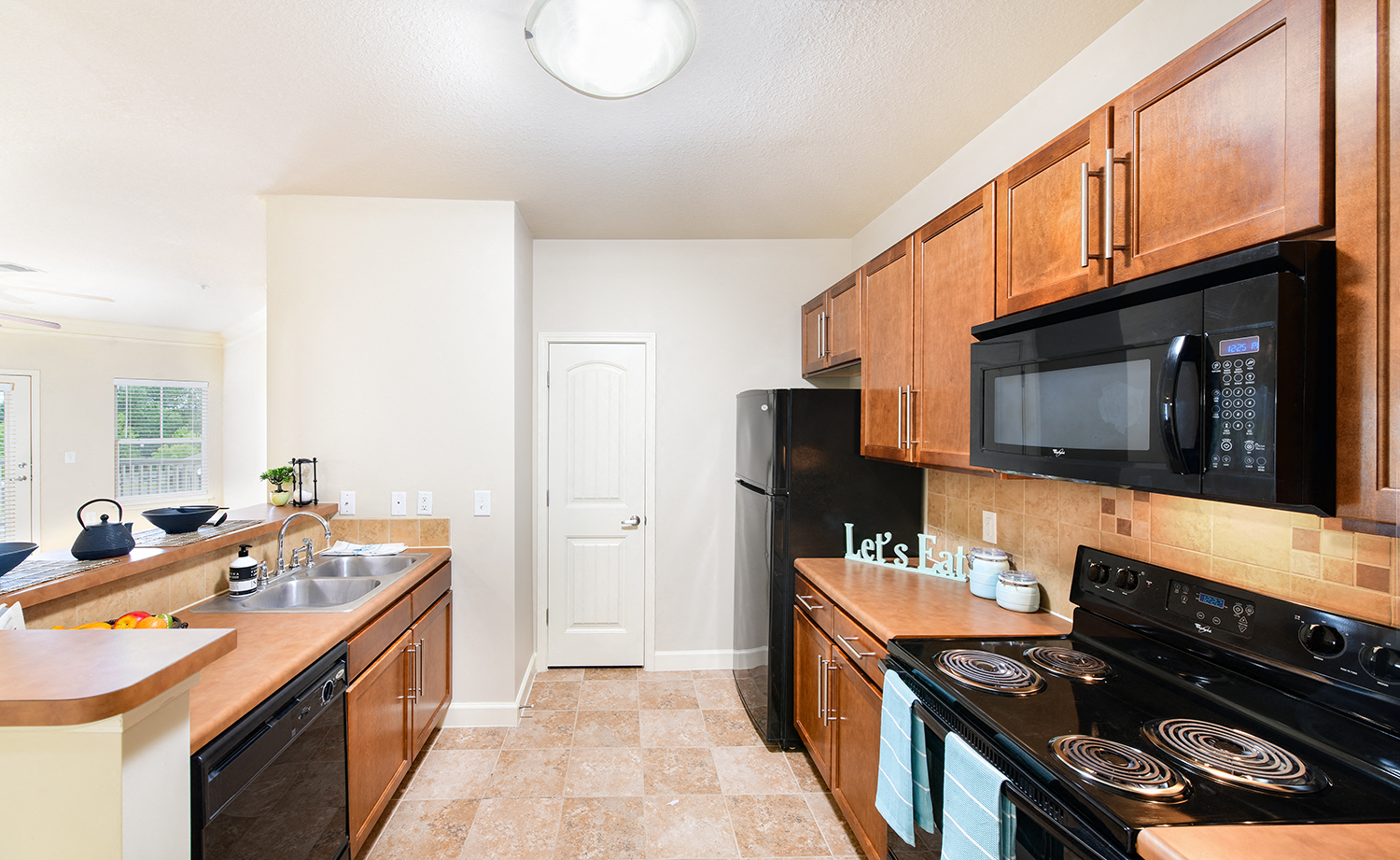 a kitchen with black appliances and wooden cabinets
