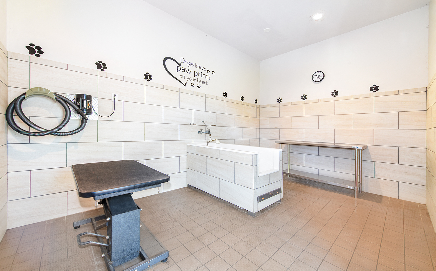 a bathroom with a tub and a sink and a bench