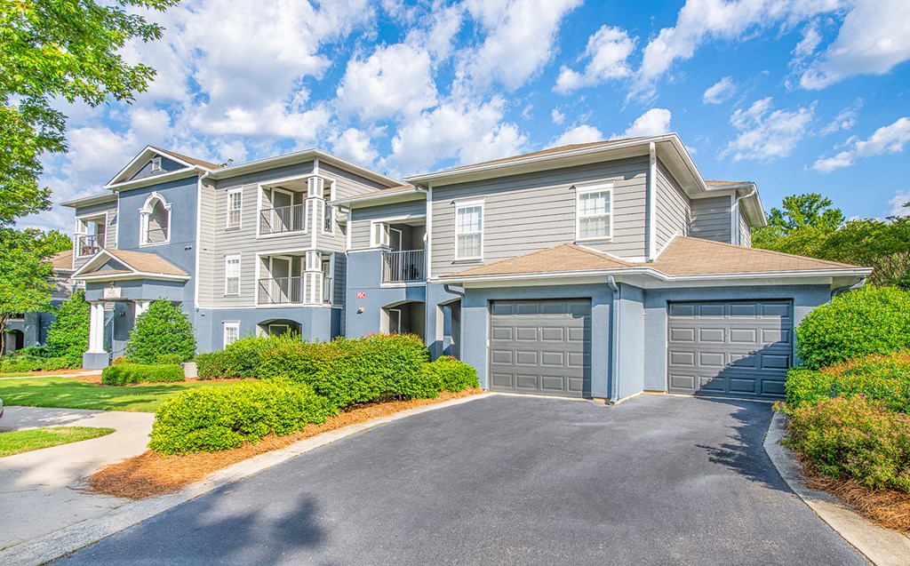 a blue house with a garage and a driveway