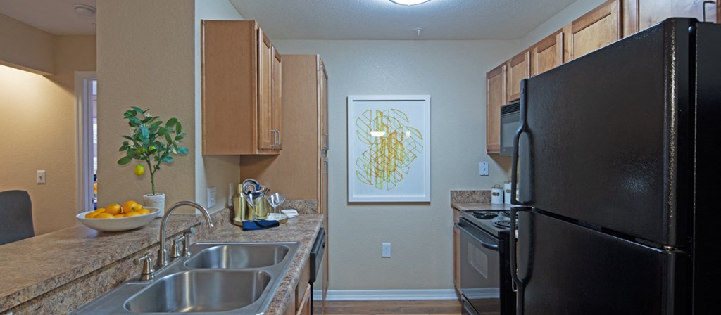 a kitchen with stainless steel appliances and granite counter tops