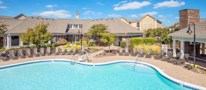 a swimming pool with a house in the background
