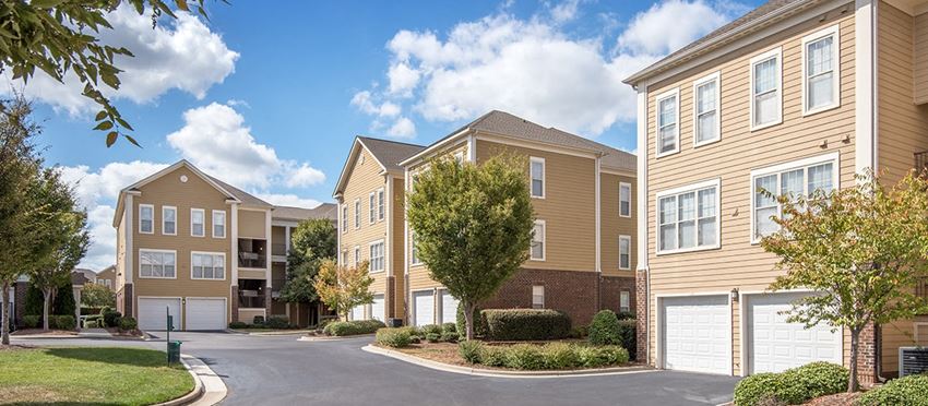 an apartment building with a street in front of it