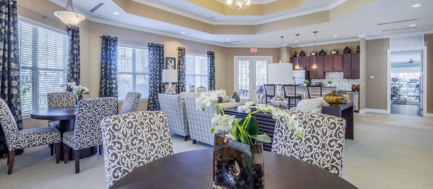 a living room with couches and chairs and a dining table