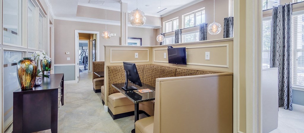 a living room with a couch and a counter with two computers