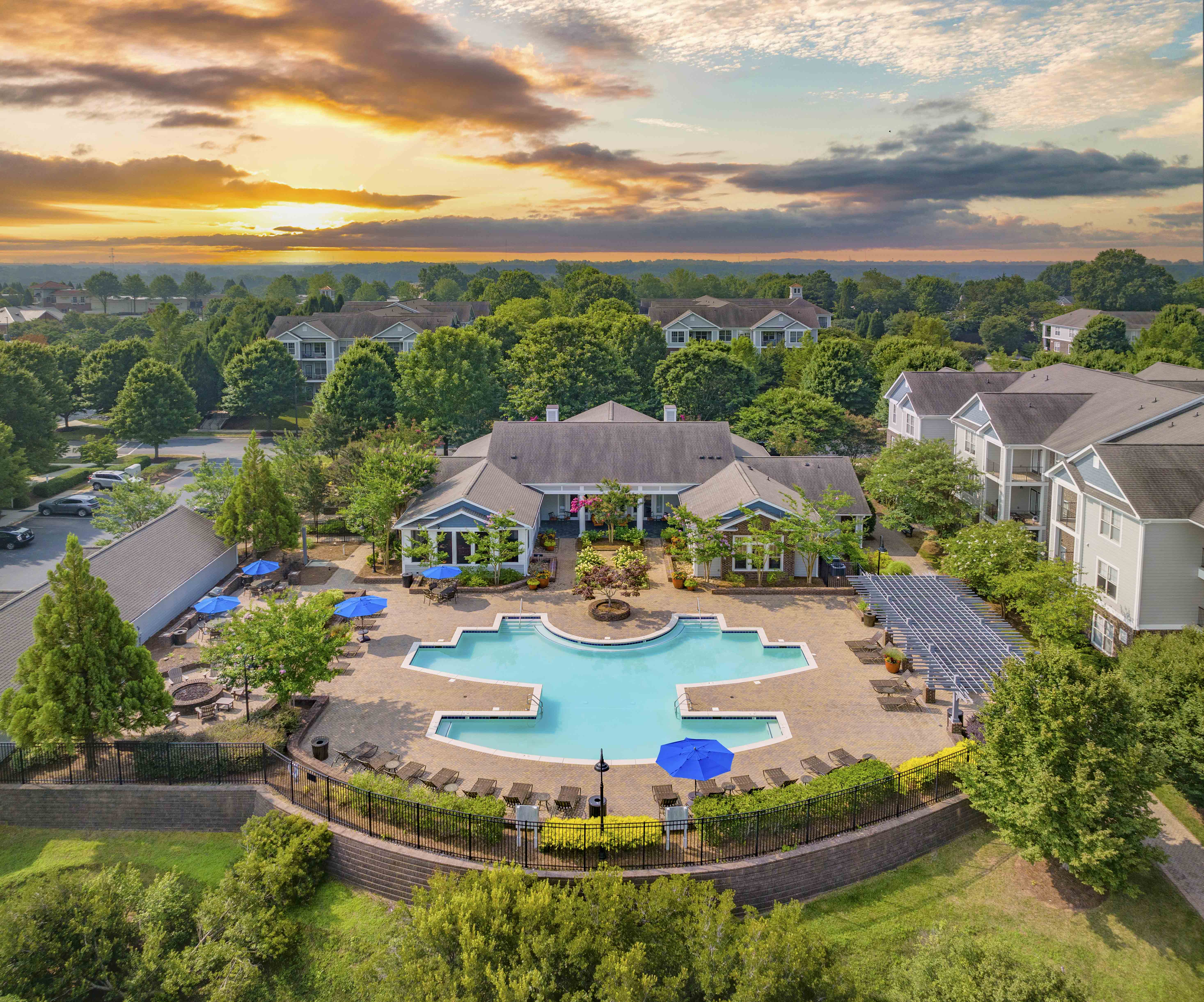 an aerial view of a swimming pool in front of a house