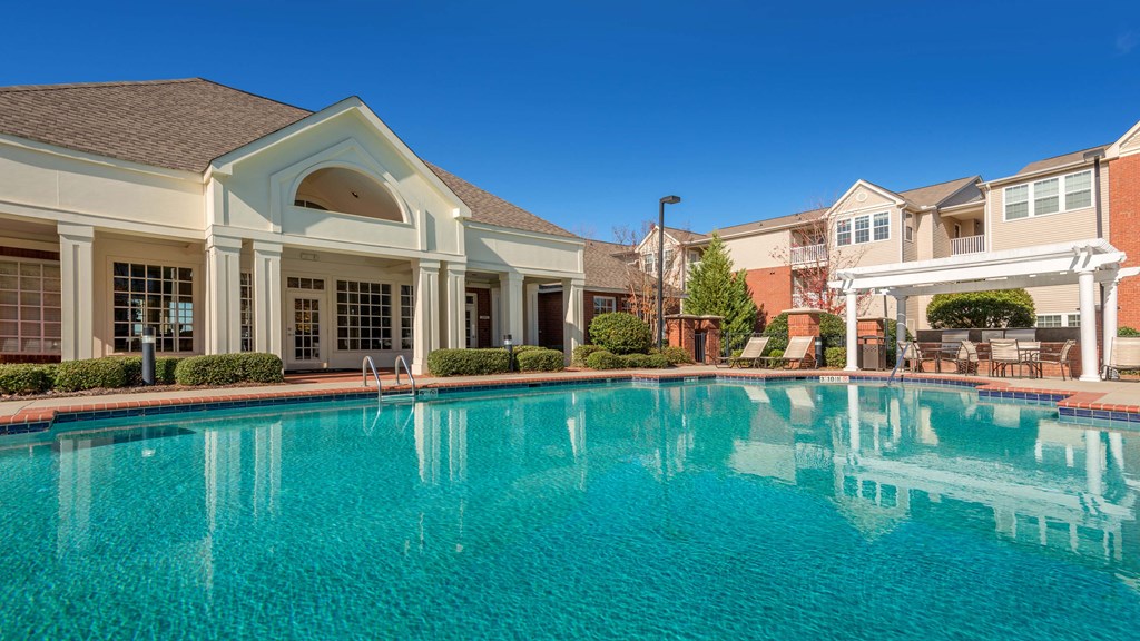 a large swimming pool with apartments in the background