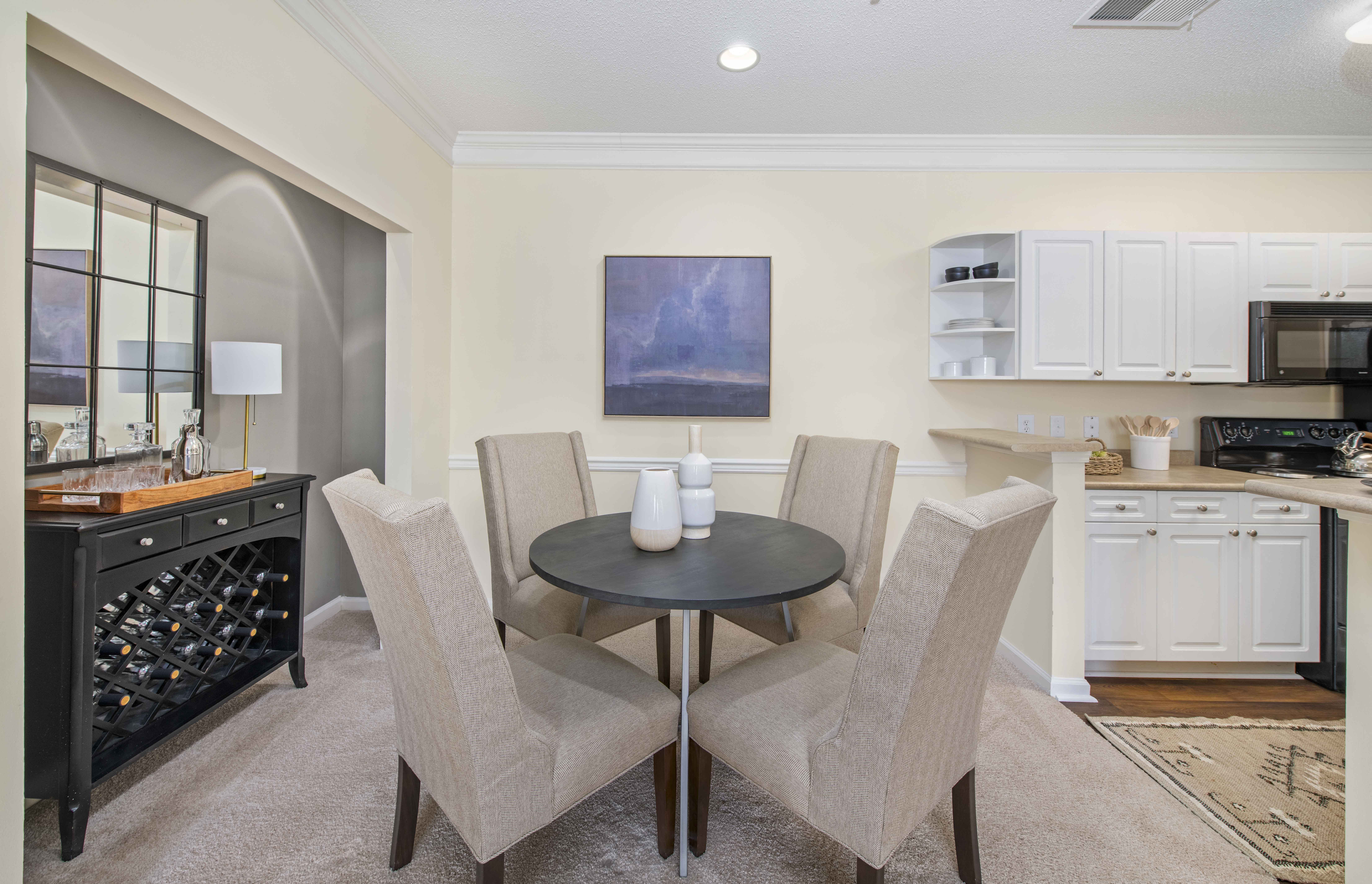 a dining room and kitchen with a table and chairs