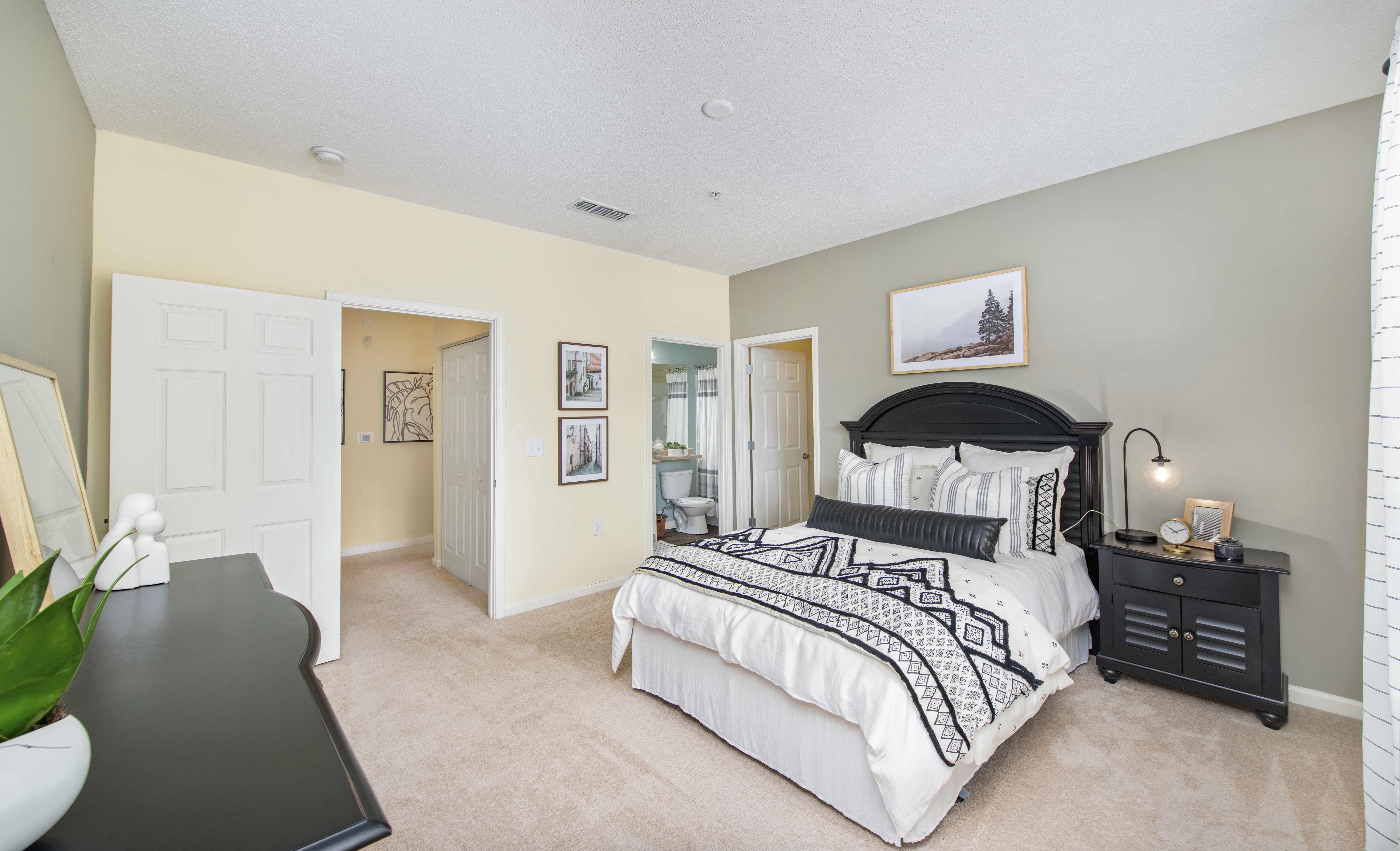 a bedroom with a large bed and a closet