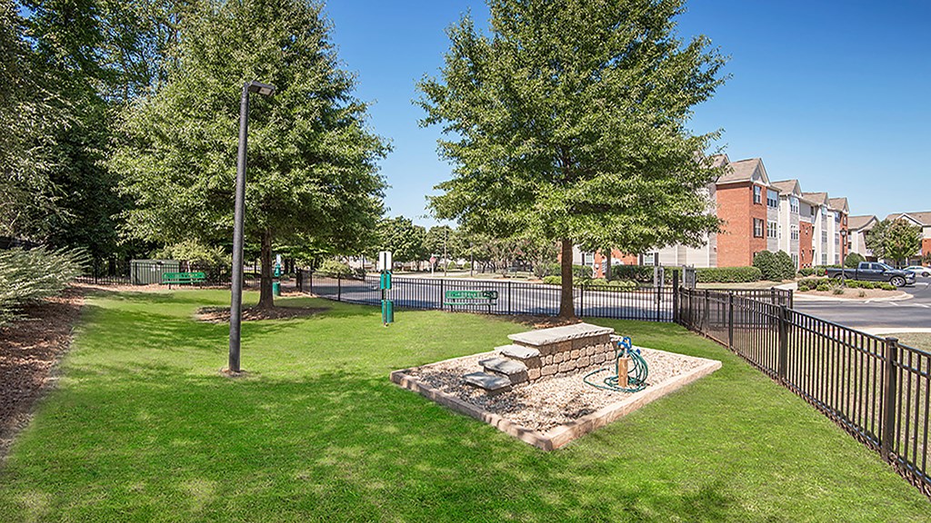 a park with a playground and trees next to a street