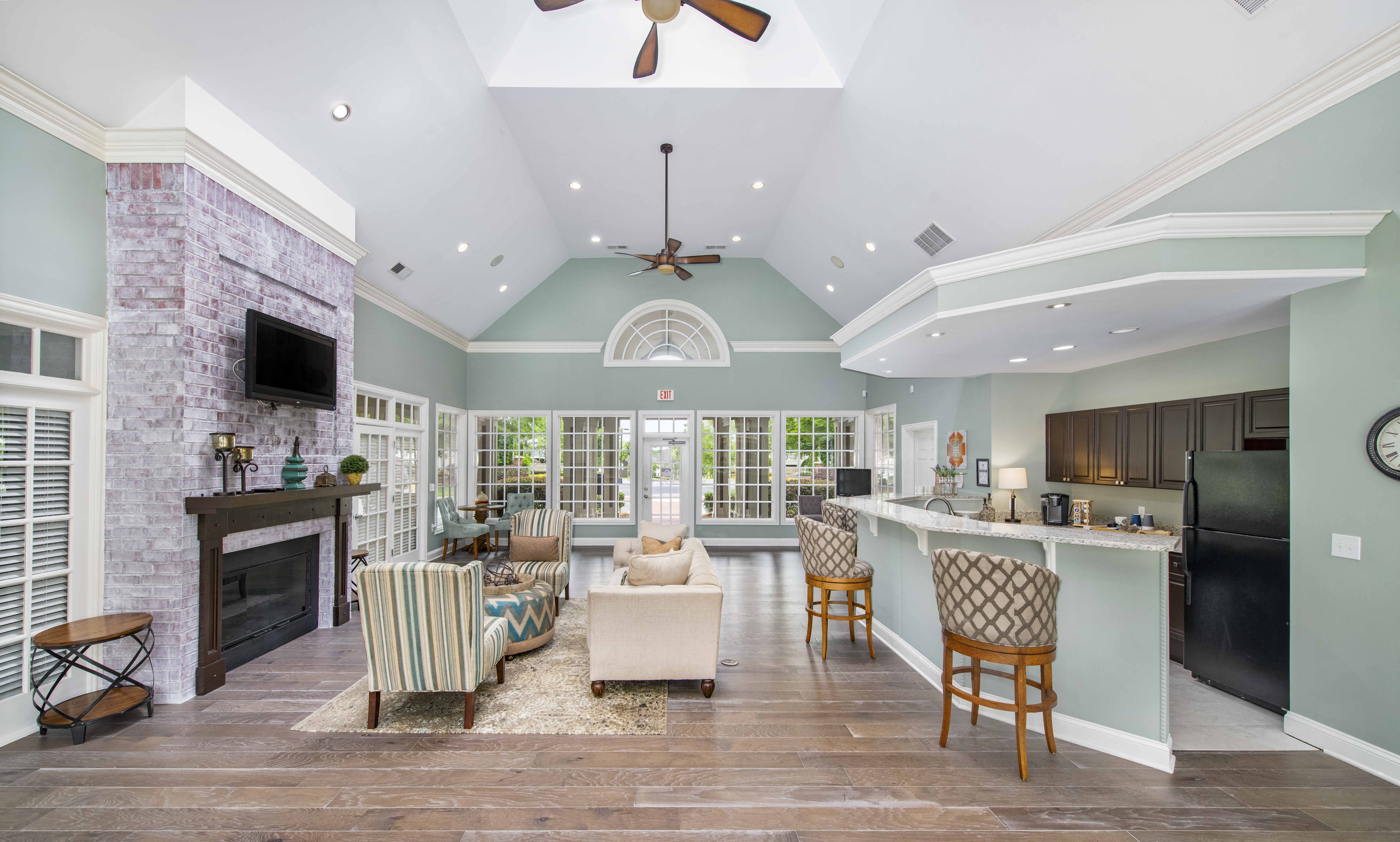 a living room with a fireplace and a kitchen