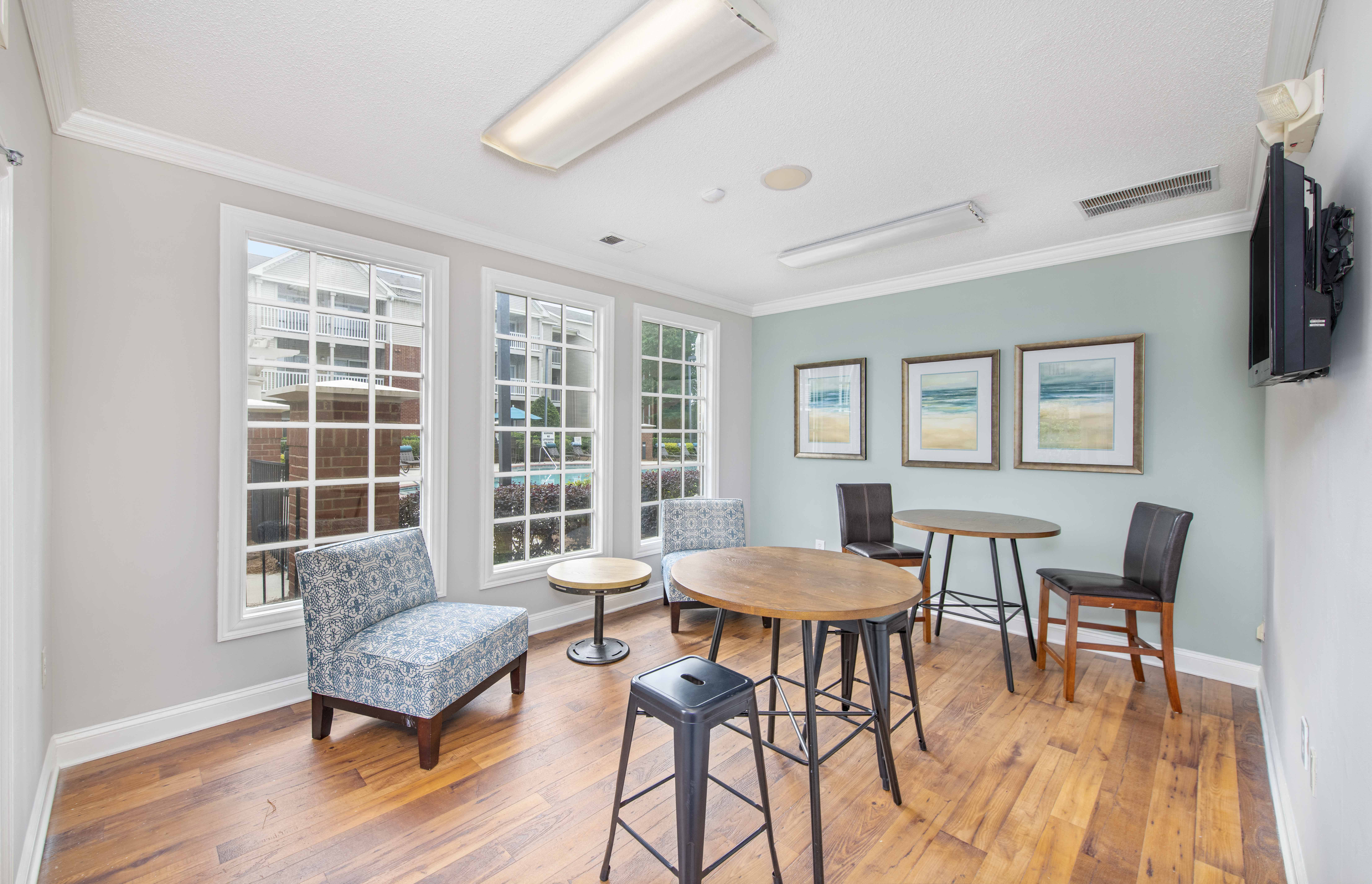 a living room with a table and chairs and a tv