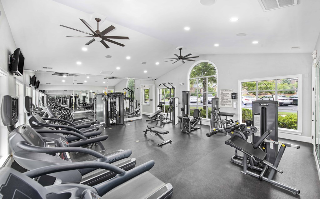 A gym with treadmills, exercise bikes, and other equipment.