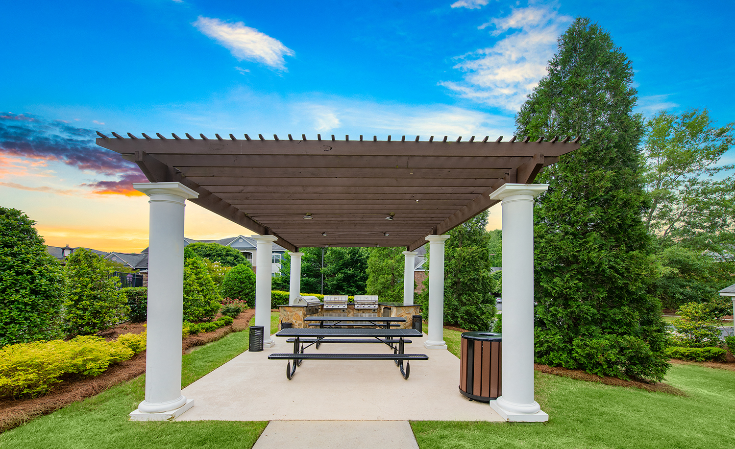 a picnic area with a table and benches under a pavilion