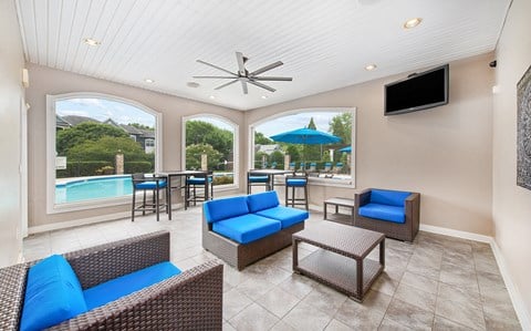 a living room with couches and chairs and a pool