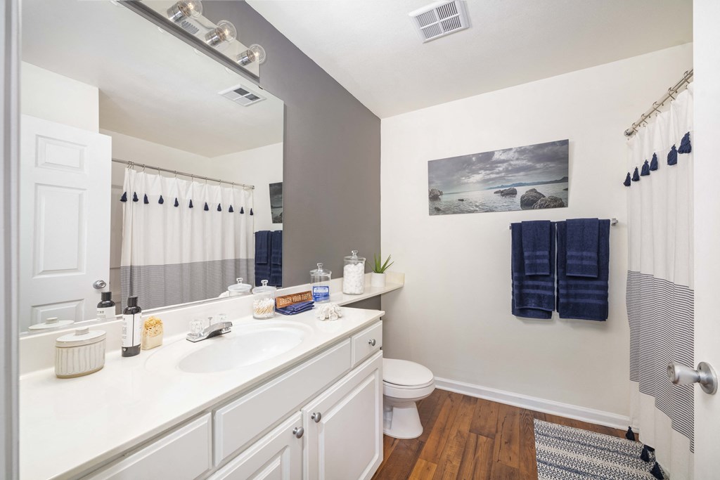 A bathroom with a white sink and a toilet.