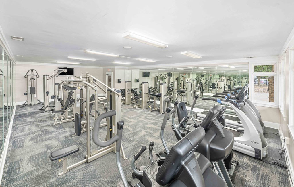 A well-equipped gym with various exercise machines.