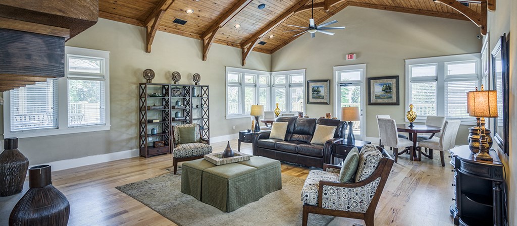 a living room with a vaulted ceiling and wood floors