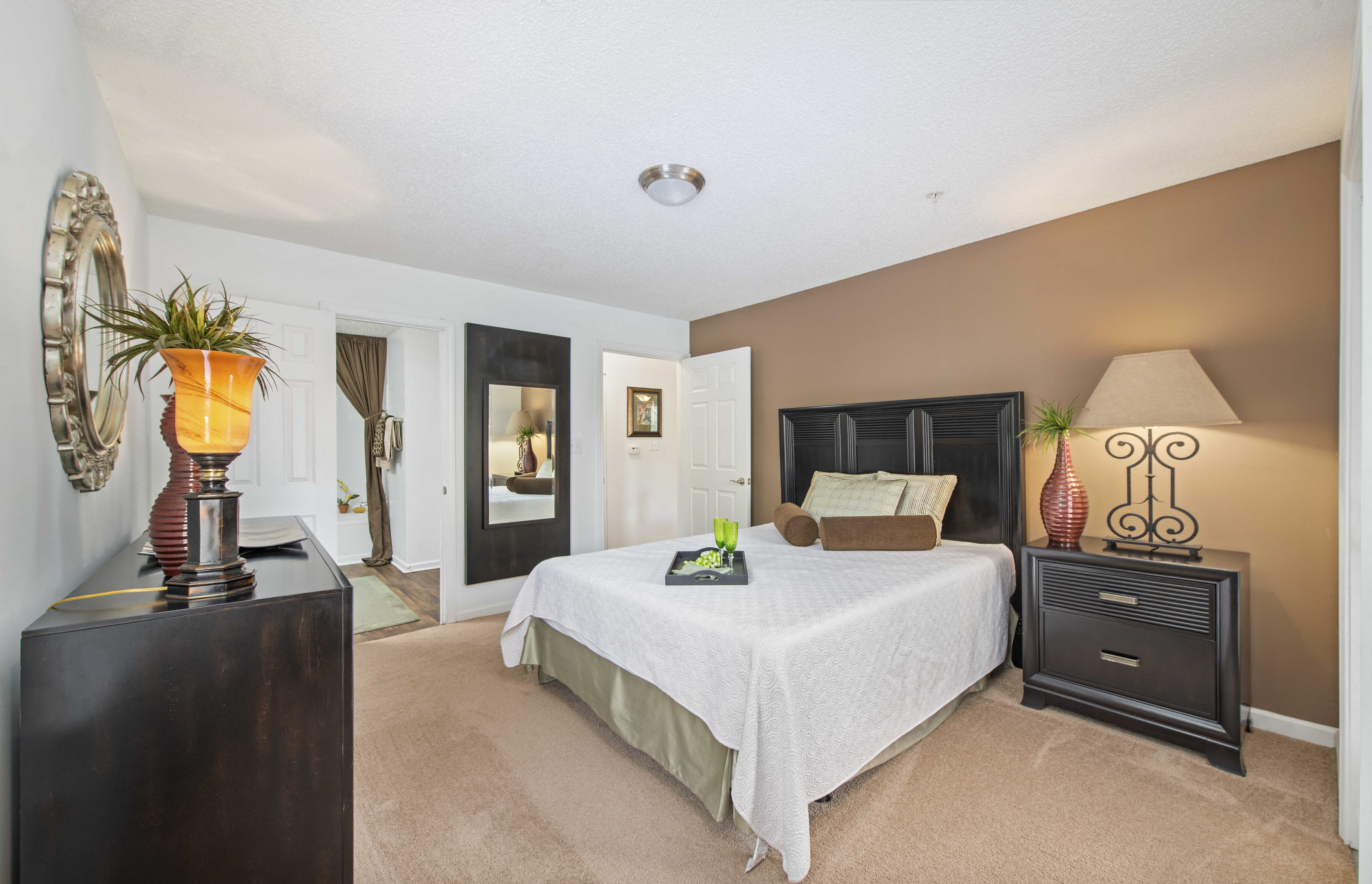 a bedroom with a large bed and a dresser