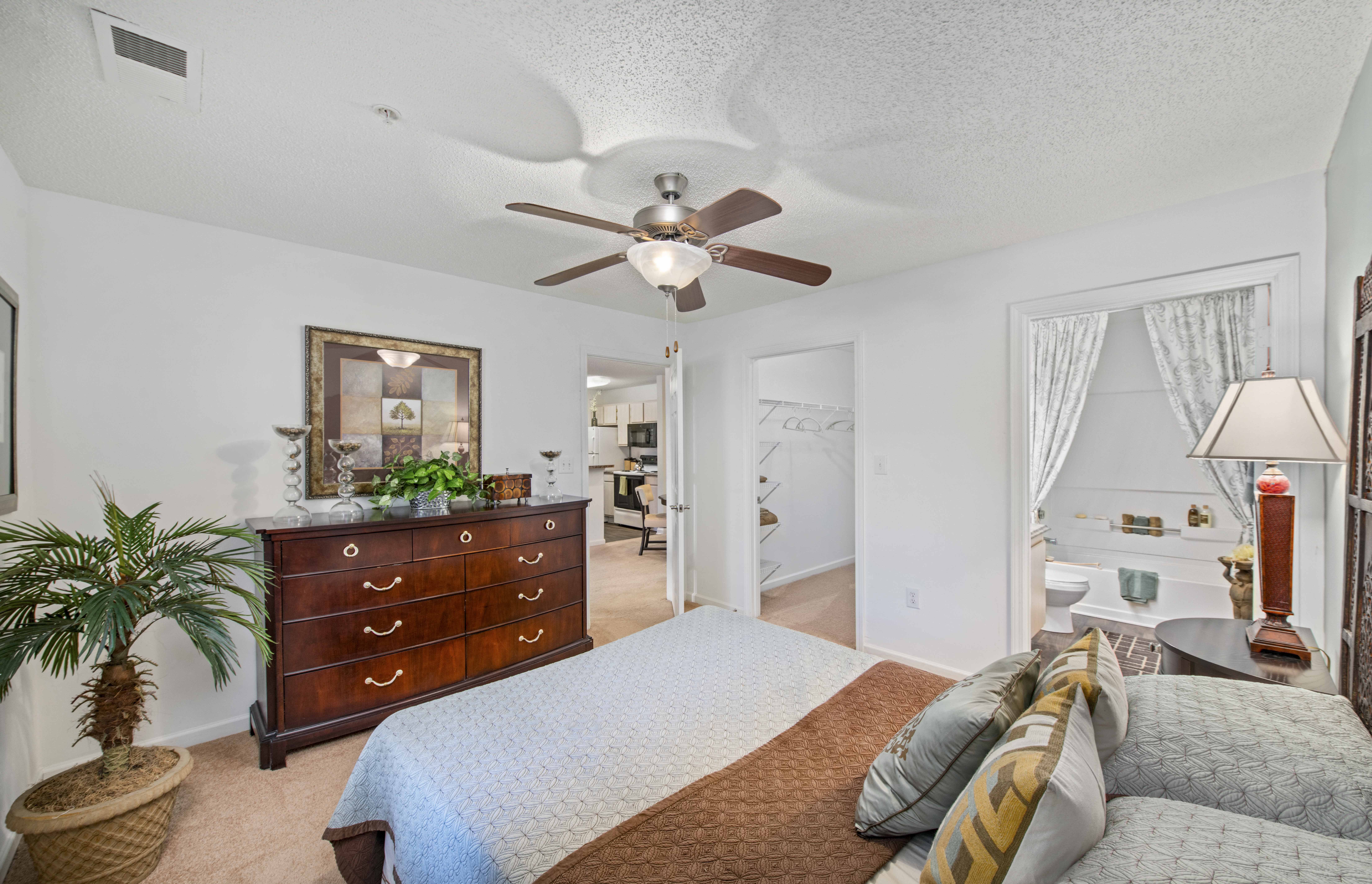 a bedroom with a bed and a ceiling fan