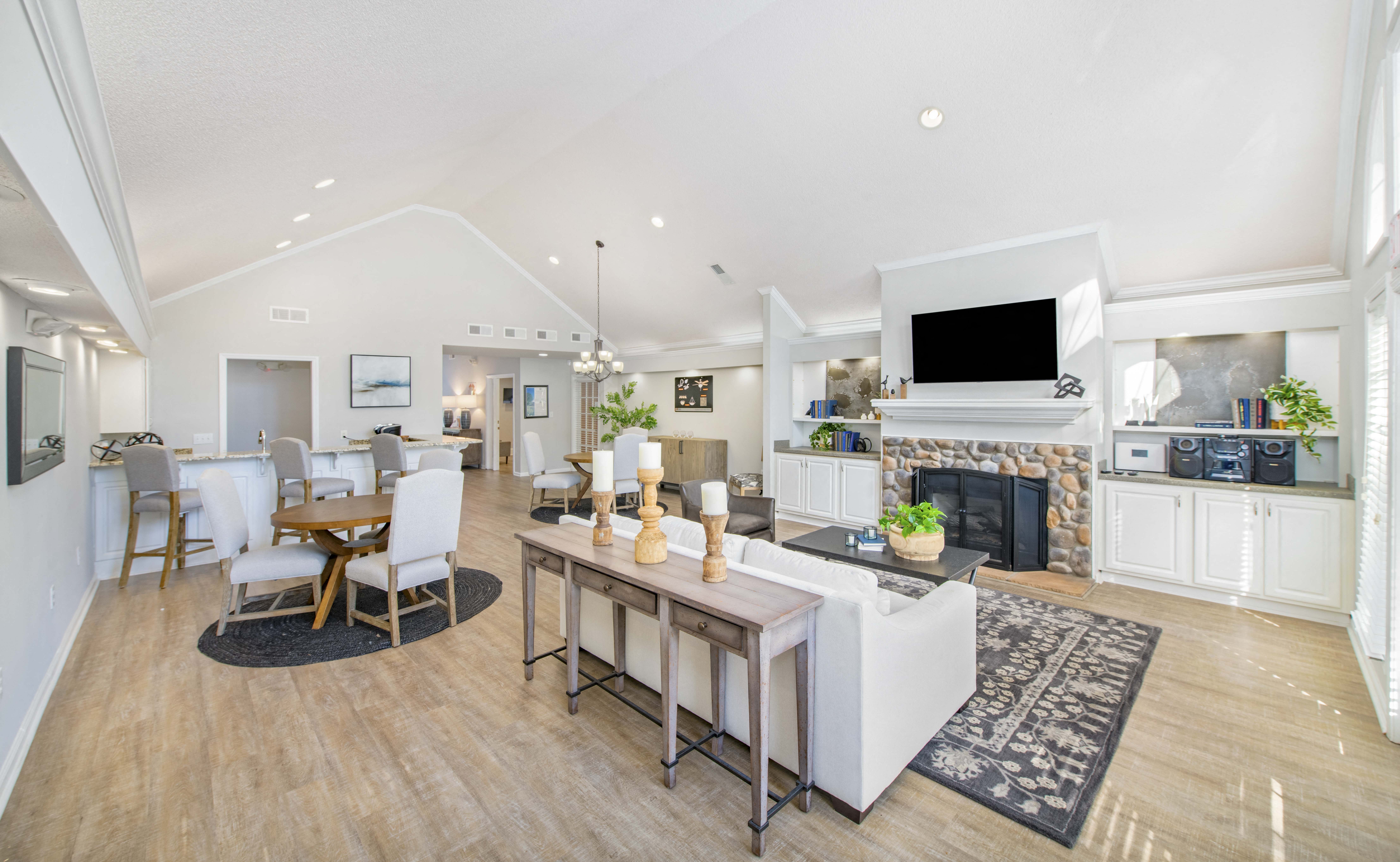 a living room with a fireplace and a dining room