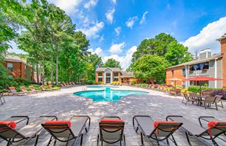 the preserve at ballantyne commons pool area with chairs and tables and apartment buildings