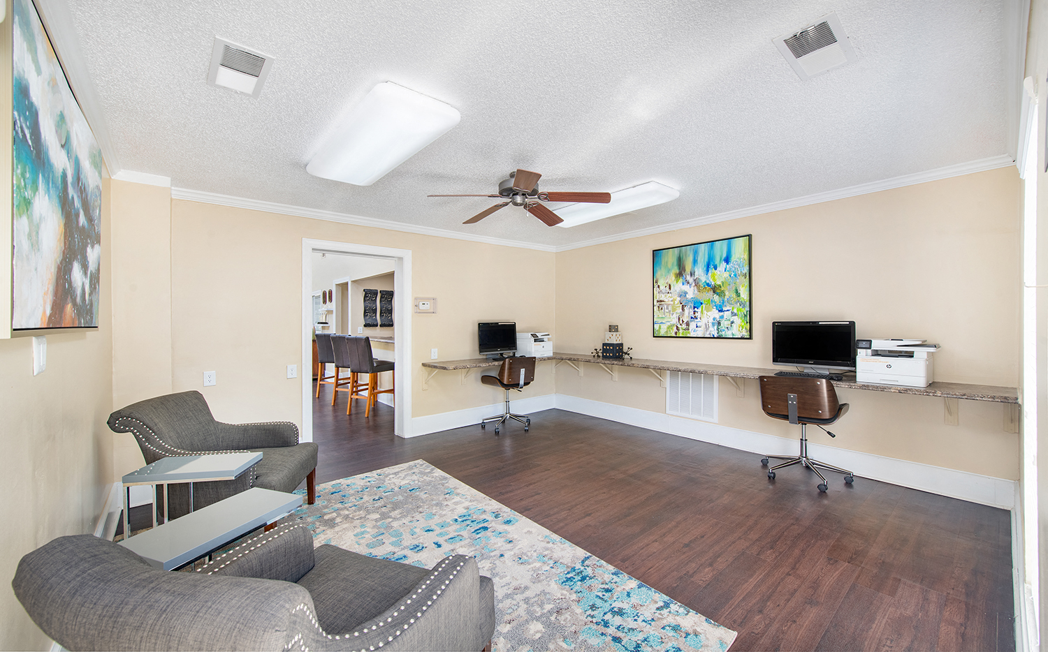 a living room with furniture and a ceiling fan