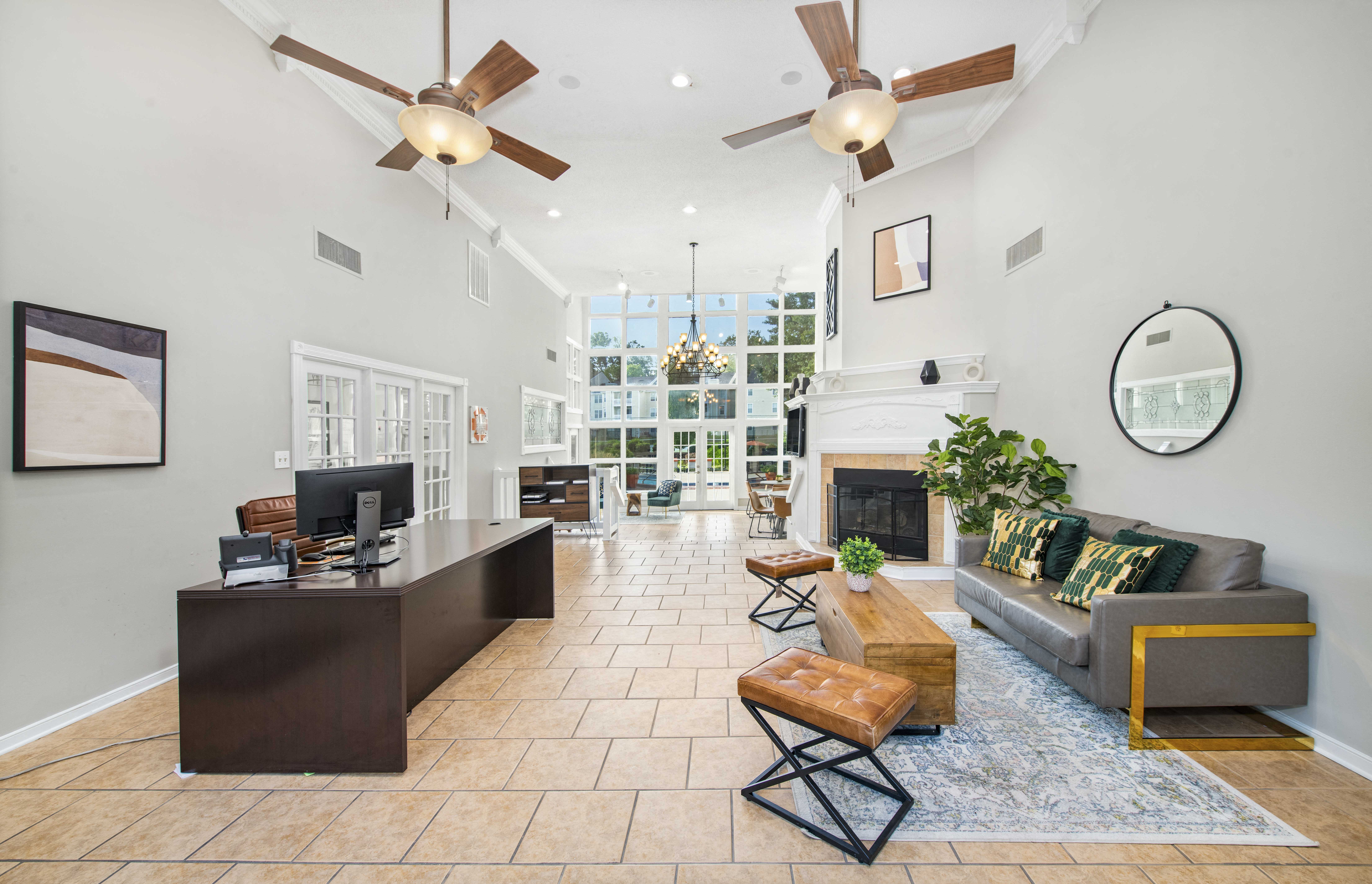 a living room with two ceiling fans and a fireplace