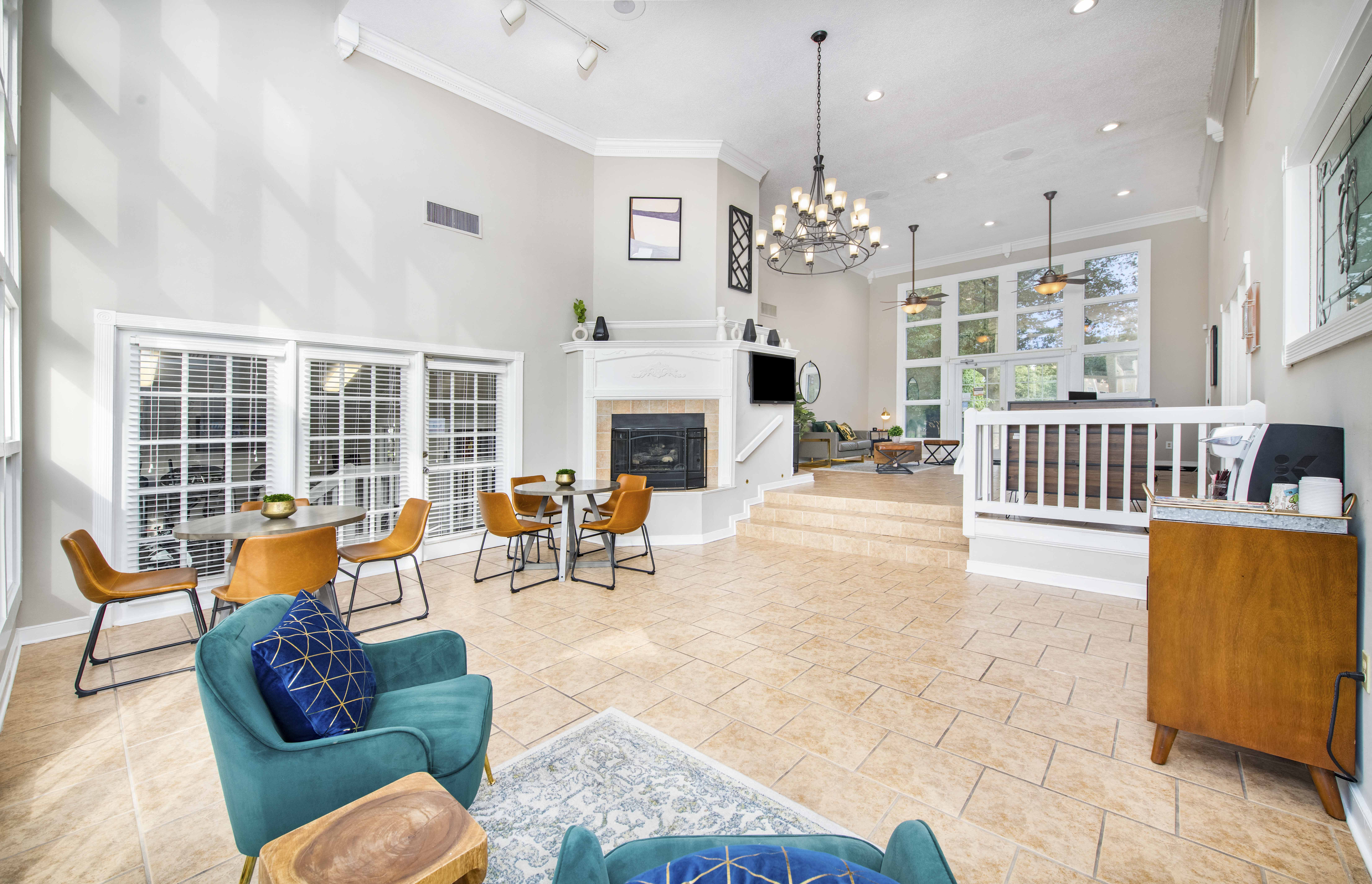 a living room with a fireplace and a table with chairs