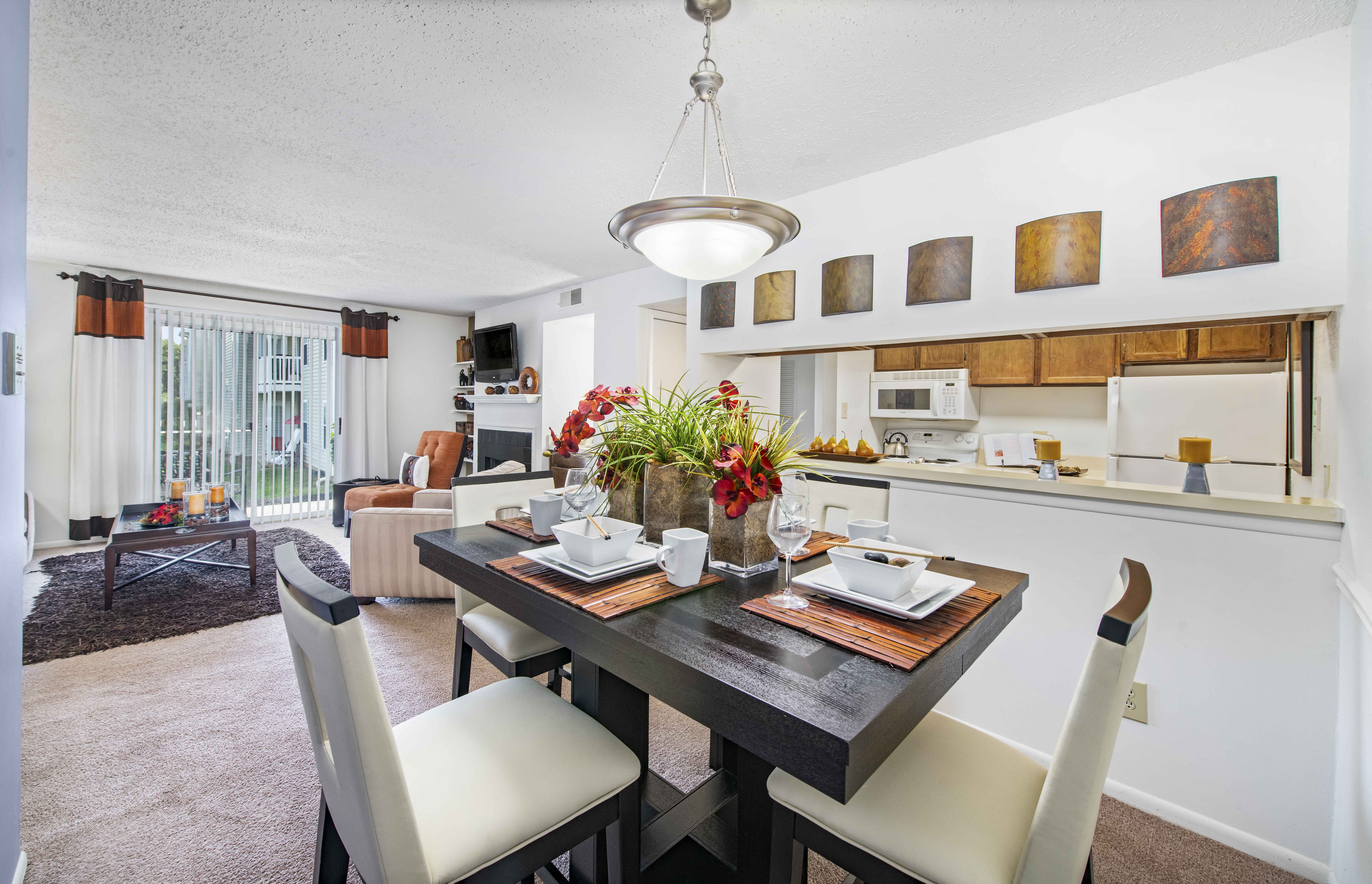 a dining area with a table and chairs and a living room