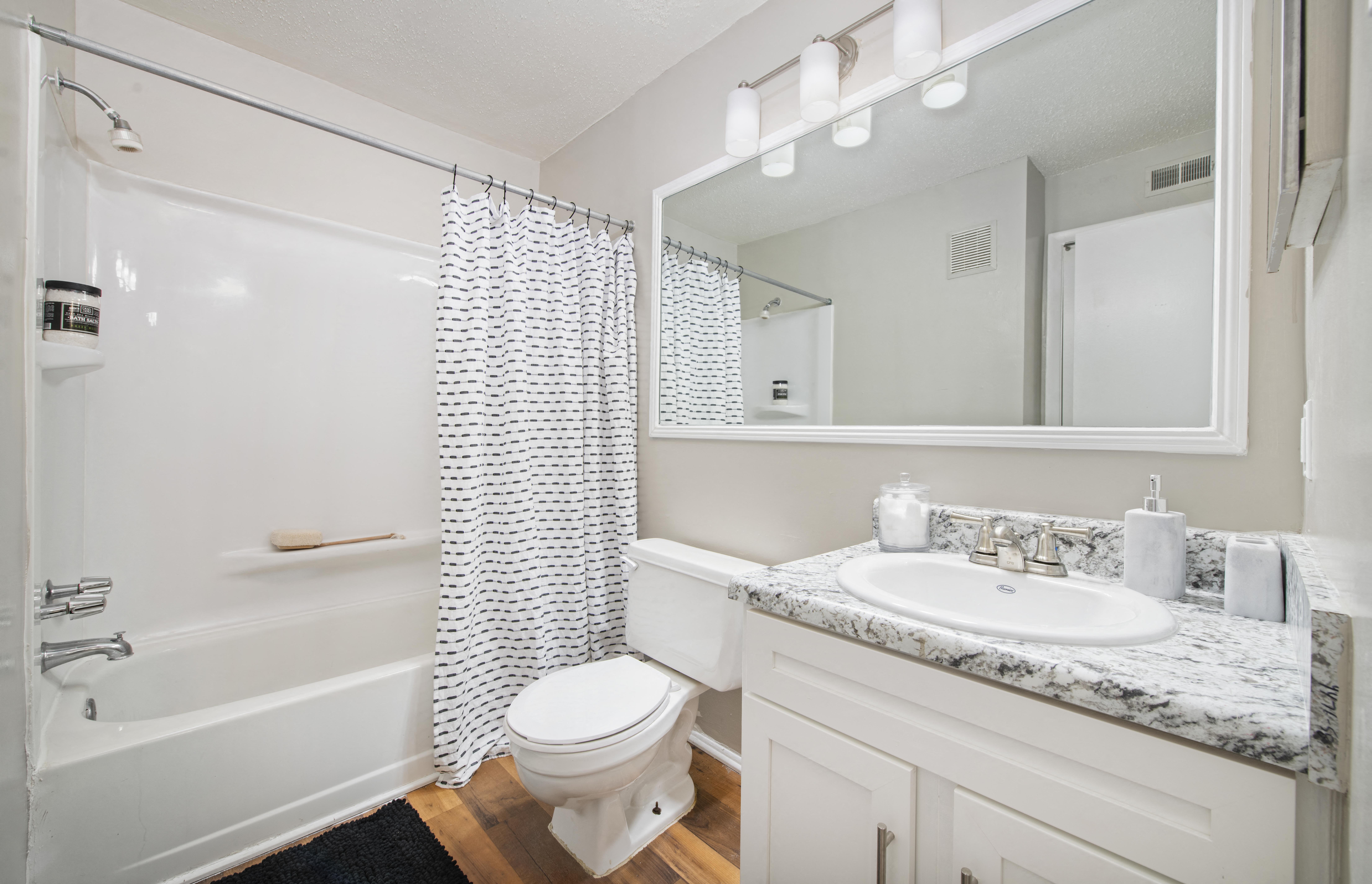 a bathroom with a shower toilet and sink