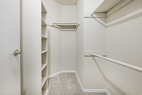 A white hallway with a carpeted stairway leading to the second floor.