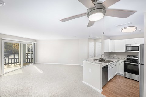 A spacious kitchen with white cabinets and a large island.