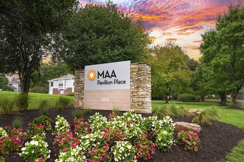 A sign for MAA Pavilion Place stands in front of a building.