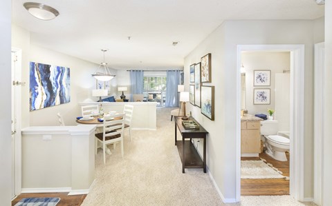 A white kitchen with a table and chairs.