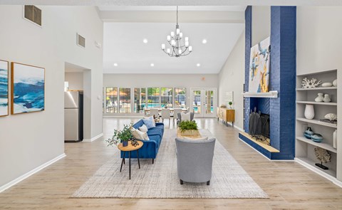 A living room with a blue couch and a grey armchair.