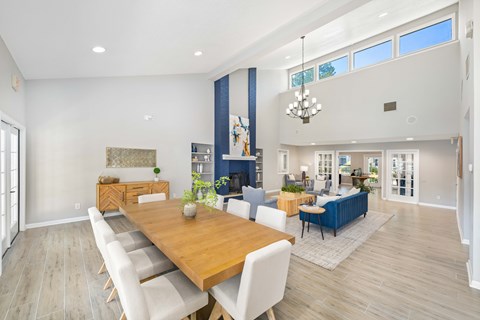 A dining room with a wooden table and chairs.