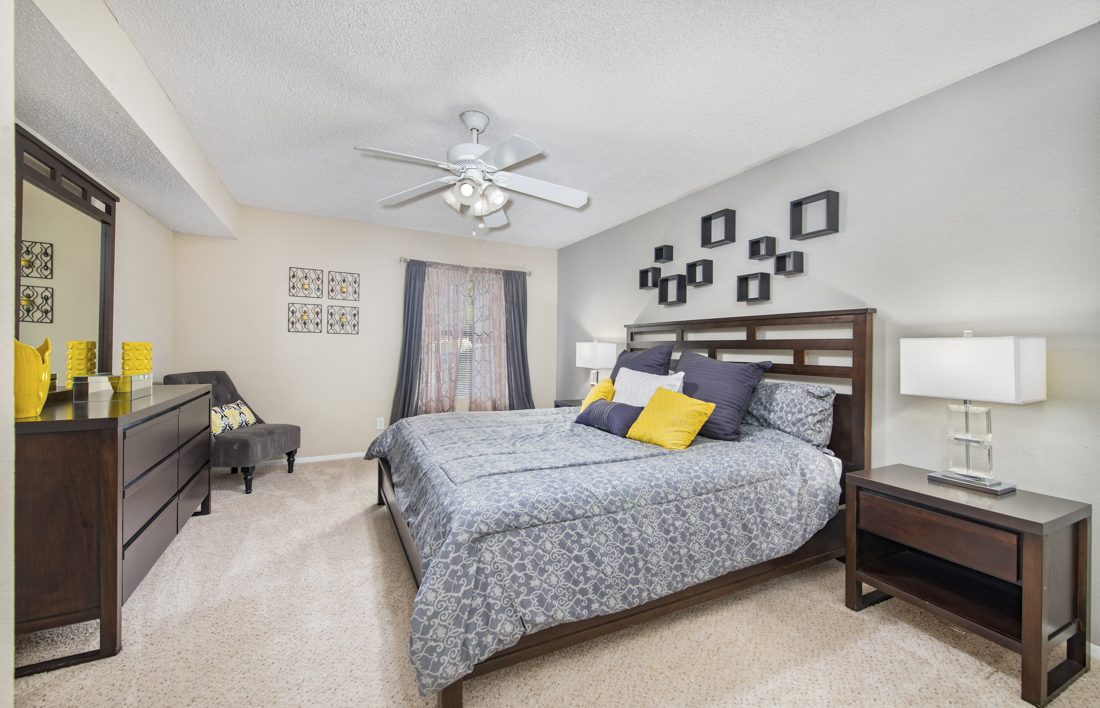 a bedroom with a bed and a ceiling fan