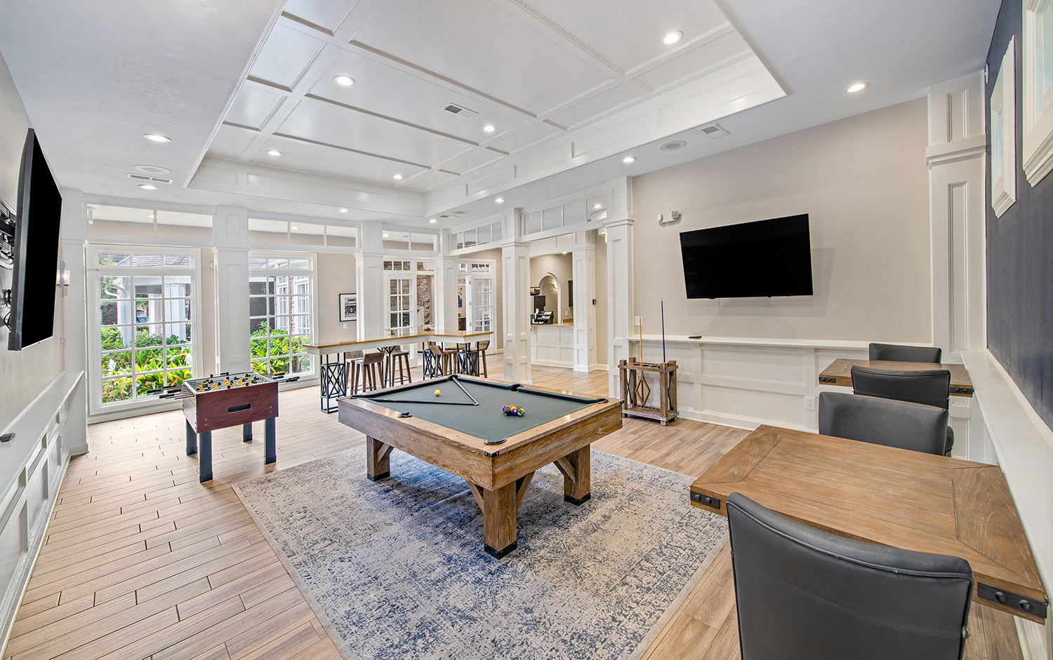 a game room with a pool table and a television