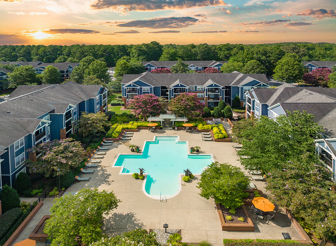 an aerial view of a community center with an oversized swimming pool