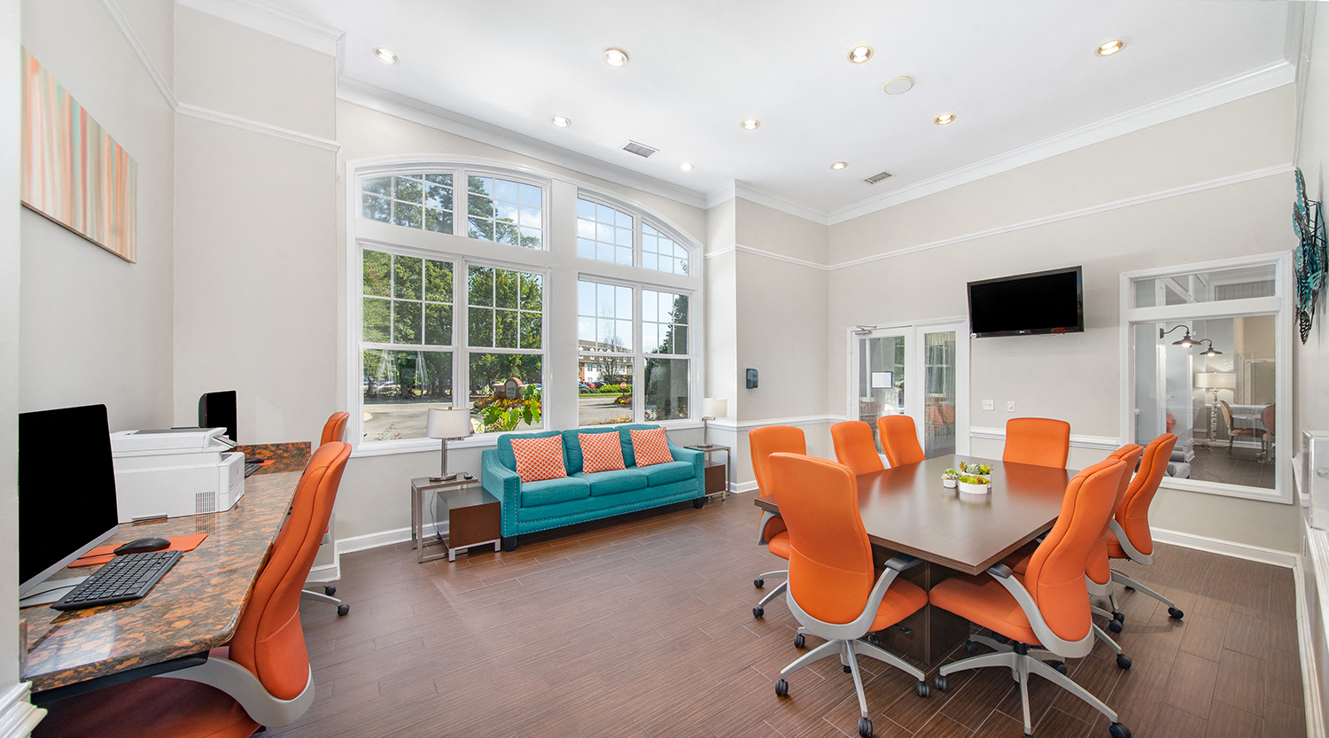 a conference room with a table and chairs and a large window