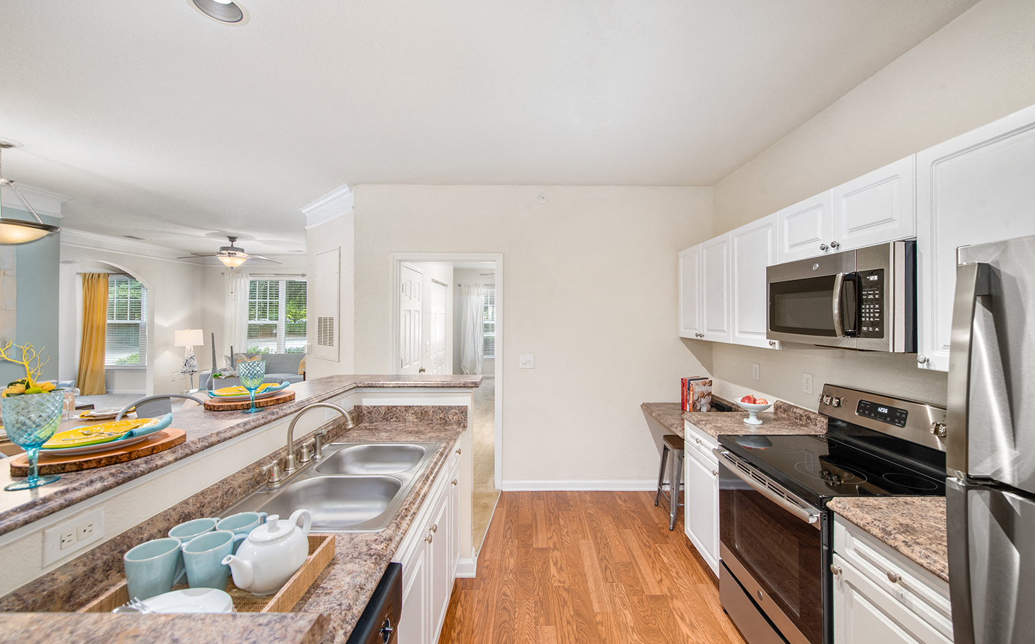 a kitchen with granite counter tops and stainless steel appliances