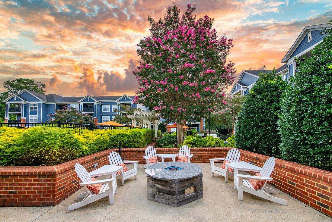 an outdoor patio with chairs and a fire pit