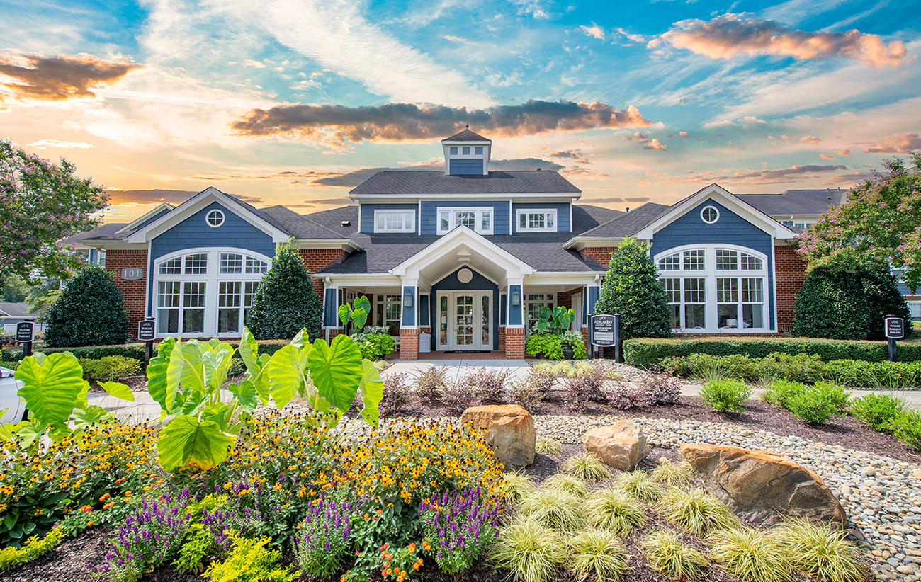 a large house with a garden in front of it